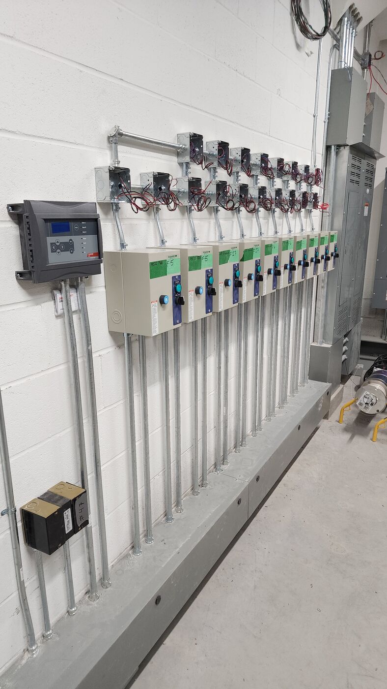 Gas-detection controller and labelled pressurization and exhaust fan starters with sensor wiring for a high-rise garage CO system.