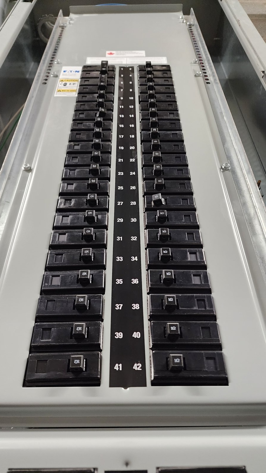 Close-up view of a residential electrical panel with circuit breakers