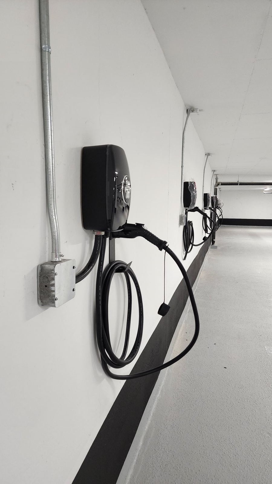 Multiple EV chargers installed in a multi-residential building parking garage